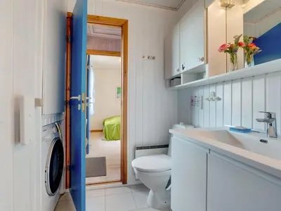 a white bathroom with a toilet and a sink at Holiday Home Dana - 290m from the sea by Interhome in Saltum