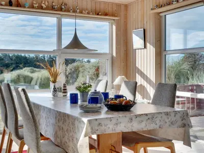 a dining room with a table with a bowl of fruit on it at Holiday Home Dana - 290m from the sea by Interhome in Saltum