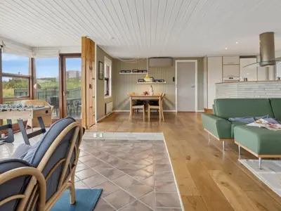 a living room with a couch and a table at Holiday Home Jobst - 150m from the sea by Interhome in Saltum