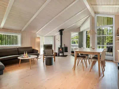 a living room with a couch and a table at Holiday Home Barnet - 2-2km from the sea by Interhome in Blokhus