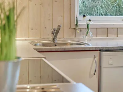a kitchen counter with a sink and a window at Holiday Home Sighwarth - 350m from the sea by Interhome in Saltum