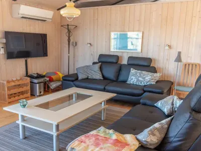 a living room with a couch and a coffee table at Holiday Home Sighwarth - 350m from the sea by Interhome in Saltum