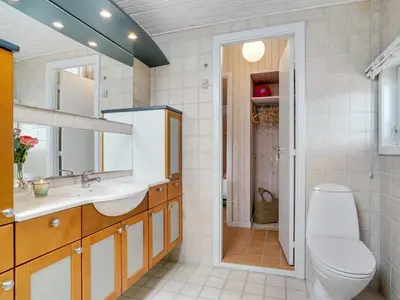 a bathroom with a toilet and a sink at Holiday Home Erwith - 50m from the sea by Interhome in Blokhus