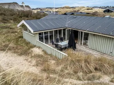 a house with solar panels on top of a beach at Holiday Home Erwith - 50m from the sea by Interhome in Blokhus
