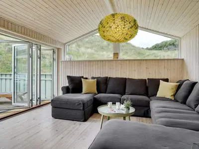a living room with a couch and a table at Holiday Home Erwith - 50m from the sea by Interhome in Blokhus
