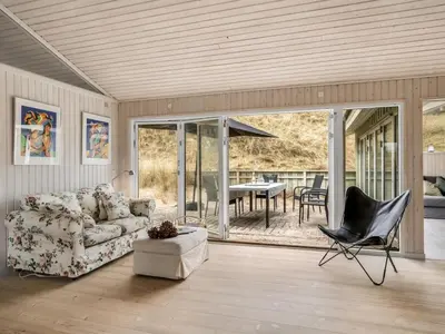 a living room with a couch and a table at Holiday Home Erwith - 50m from the sea by Interhome in Blokhus