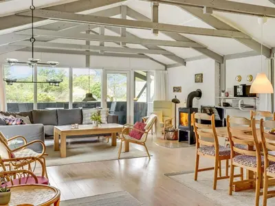 a living room with a couch and a table at Holiday Home Eivy - 1km from the sea by Interhome in Saltum