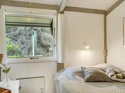 a bedroom with a bed and a window at Holiday Home Eivy - 1km from the sea by Interhome in Saltum
