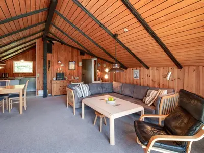 a living room with a couch and a table at Holiday Home Maritha - 950m from the sea by Interhome in Saltum