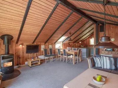a living room with a kitchen and a stove at Holiday Home Maritha - 950m from the sea by Interhome in Saltum