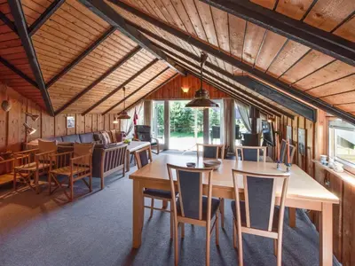 a dining room with a table and chairs at Holiday Home Maritha - 950m from the sea by Interhome in Saltum