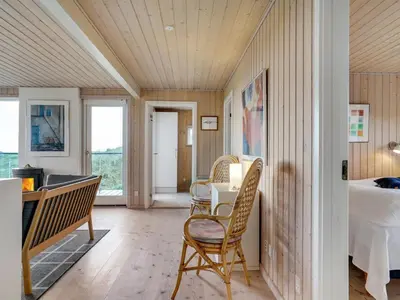a room with a table and chairs and a bedroom at Holiday Home Josten - 500m from the sea by Interhome in Saltum