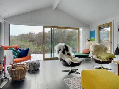 a living room with a dog sitting on the floor at Holiday Home Simeona - 140m from the sea by Interhome in Saltum