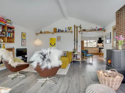 a living room with a couch and chairs and a table at Holiday Home Simeona - 140m from the sea by Interhome in Saltum