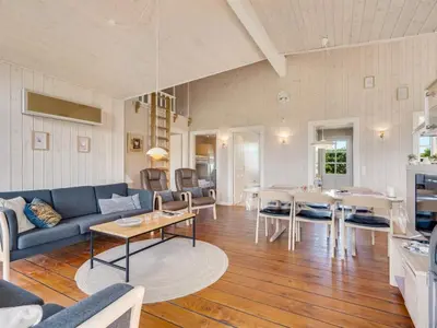 a living room with a couch and a table at Holiday Home Annemie - 1-8km from the sea by Interhome in Saltum
