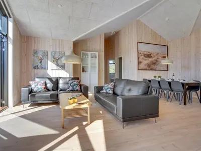 a living room with a couch and a table at Holiday Home Bentine - 1-6km from the sea by Interhome in Saltum