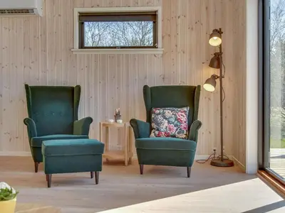 two green chairs in a living room with a pillow at Holiday Home Bentine - 1-6km from the sea by Interhome in Saltum