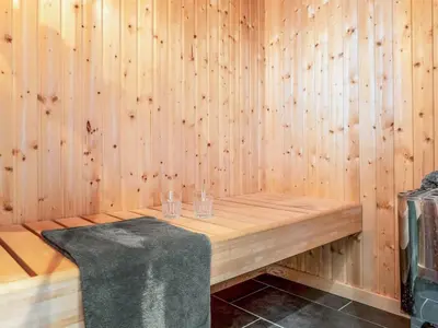 a sauna with two glasses on a table at Holiday Home Javorka - 1-4km from the sea by Interhome in Saltum