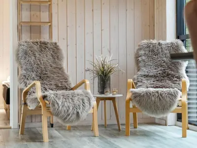 a room with two chairs with faux fur at Holiday Home Javorka - 1-4km from the sea by Interhome in Saltum