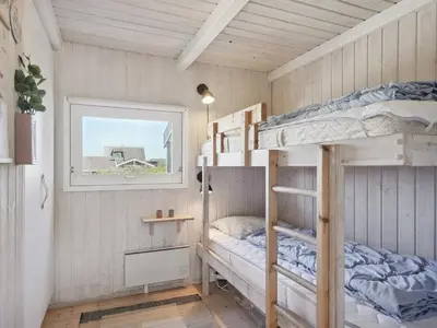 a bedroom with bunk beds in a house at Holiday Home Dijana - 150m from the sea by Interhome in Saltum