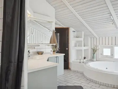 a white bathroom with two sinks and a tub at Holiday Home Dijana - 150m from the sea by Interhome in Saltum