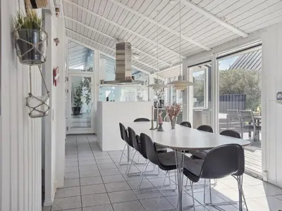 a dining room with a table and chairs at Holiday Home Dijana - 150m from the sea by Interhome in Saltum