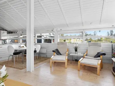 a living room with a table and chairs at Holiday Home Allida - 800m from the sea by Interhome in Saltum