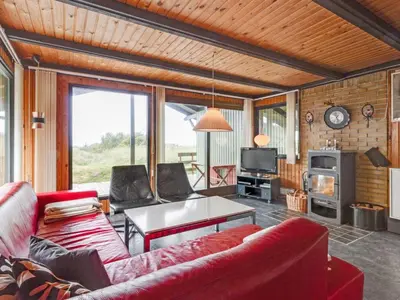 a living room with a couch and a table at Holiday Home Maini - 600m from the sea by Interhome in Saltum