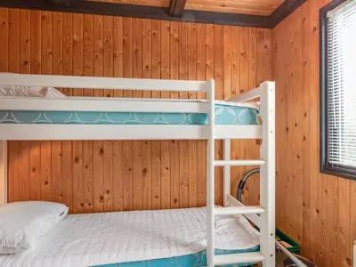 a bunk bed room with two bunk beds in a cabin at Holiday Home Maini - 600m from the sea by Interhome in Saltum