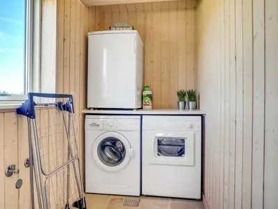 a washer and dryer with a refrigerator on top of it at Holiday Home Dorothe - 1-4km from the sea by Interhome in Saltum