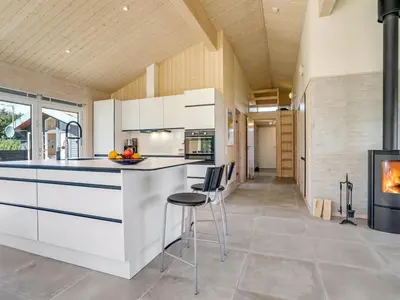a kitchen with white cabinets and a stove at Holiday Home Dorothe - 1-4km from the sea by Interhome in Saltum