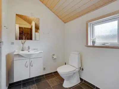 a bathroom with a toilet and a sink at Holiday Home Alhed - 650m from the sea by Interhome in Saltum