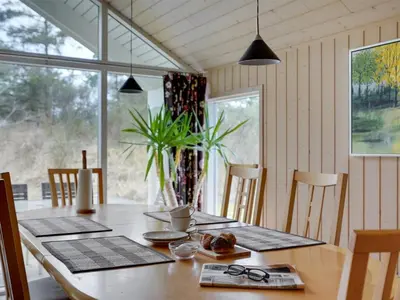 a dining room table with glasses and a plant at Holiday Home Alhed - 650m from the sea by Interhome in Saltum