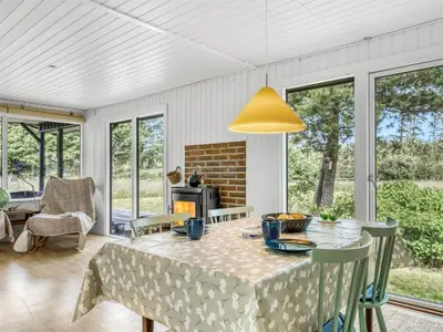 a dining room with a table and chairs at Holiday Home Jorek - 1-3km from the sea by Interhome in Saltum