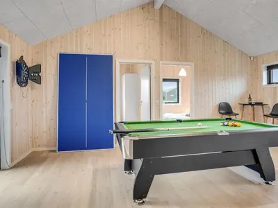 a room with a pool table and a blue door at Holiday Home Carla - 1-5km from the sea by Interhome in Saltum