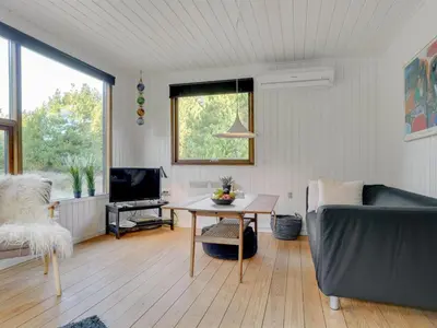 a living room with a couch and a table at Holiday Home Antoinetta - 900m from the sea by Interhome in Saltum