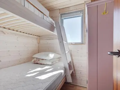 a bedroom with a bunk bed in a tiny house at Holiday Home Felis - 200m from the sea by Interhome in Saltum