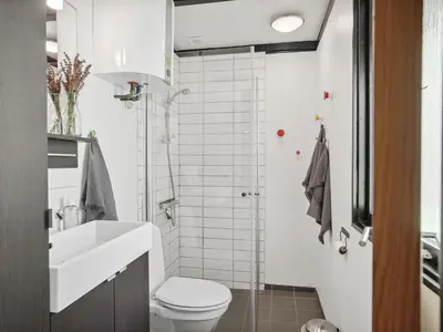 a bathroom with a white toilet and a sink at Holiday Home Therbern - 1-7km from the sea by Interhome in Saltum
