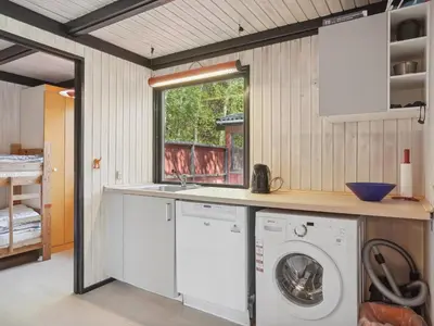 a laundry room with a washer and dryer at Holiday Home Therbern - 1-7km from the sea by Interhome in Saltum