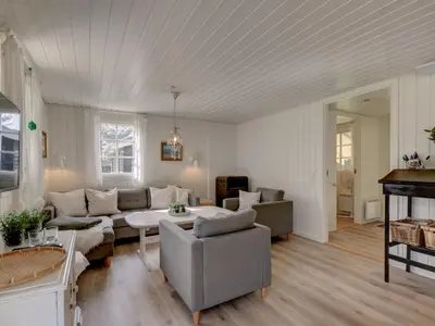 a living room with a couch and a table at Holiday Home Maunu - 1-2km from the sea by Interhome in Saltum