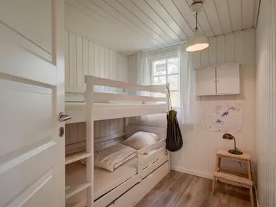 a room with two bunk beds and a window at Holiday Home Maunu - 1-2km from the sea by Interhome in Saltum