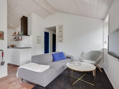 a living room with a couch and a table at Holiday Home Kadife - 750m from the sea by Interhome in Saltum