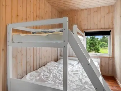 a bedroom with two bunk beds in a cabin at Holiday Home Nayati - 2km from the sea by Interhome in Saltum