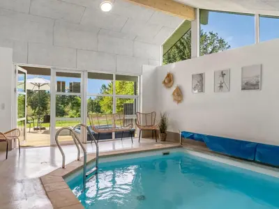 a swimming pool in the middle of a house at Holiday Home Nayati - 2km from the sea by Interhome in Saltum