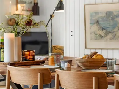a dining room table with bread and baskets of food at Holiday Home Ayelen - 600m from the sea by Interhome in Saltum