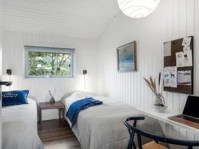 a bedroom with two beds and a desk with a laptop at Holiday Home Ayelen - 600m from the sea by Interhome in Saltum