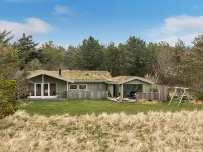 a green house with a grass roof at Holiday Home Ayelen - 600m from the sea by Interhome in Saltum