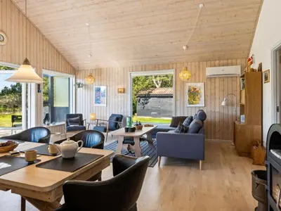 a living room with wooden walls and wooden floors at Holiday Home Swen - 1-3km from the sea by Interhome in Saltum