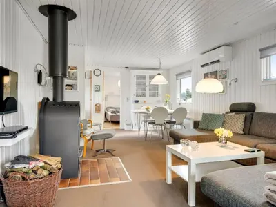 a living room with a couch and a stove at Holiday Home Gerwer - 700m from the sea by Interhome in Saltum