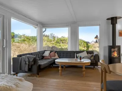 a living room with a couch and a table at Holiday Home Asser - 400m from the sea by Interhome in Saltum